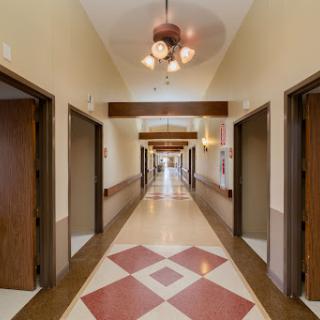 A well-lit hallway featuring multiple doors and decorative lighting.