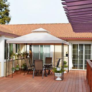 A cozy patio setup with a gazebo and outdoor furniture on a wooden deck.