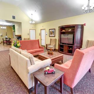 A cozy living room with comfortable seating and a television stand.