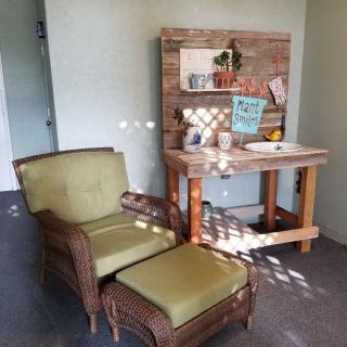 Cozy reading nook with an armchair and decorative table.