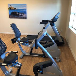 A well-equipped gym room with treadmills and exercise bikes.