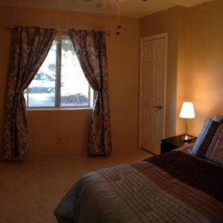 A cozy bedroom with soft lighting and decorative curtains.