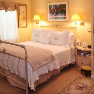 A cozy bedroom with warm lighting and elegant decor.