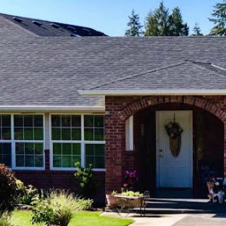 A charming brick house with a welcoming front entrance and well-maintained landscaping.