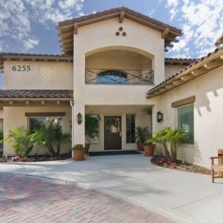 A beautiful, spacious two-story house with stucco walls and a tiled roof.