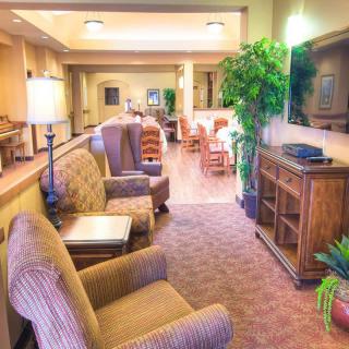 A cozy lobby with comfortable seating and warm lighting.