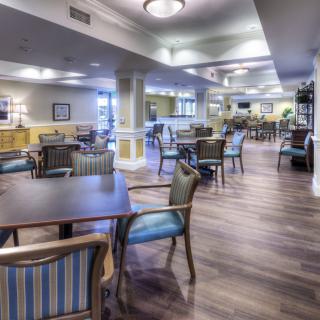 A spacious dining area with tables and chairs arranged neatly.