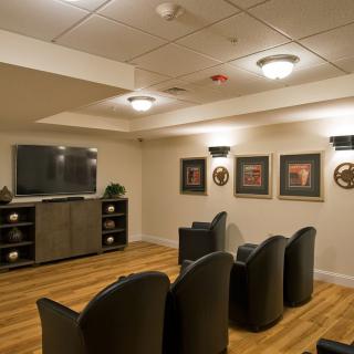 A cozy home theater setup with comfortable seating and ambient lighting.