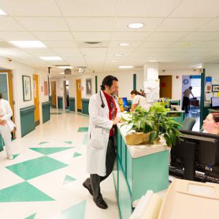 A busy hospital corridor with medical staff attending to patients.