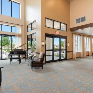 Spacious lobby with a grand piano and comfortable seating.