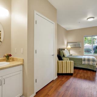 A well-furnished bedroom with modern decor, featuring a comfortable bed and stylish seating.