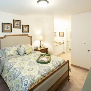 A cozy bedroom with a comfortable bed, elegant decor, and soft lighting.