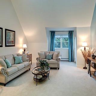 A cozy living room with neutral-toned furniture and soft lighting.