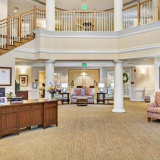 Spacious and elegantly designed lobby with a reception desk and seating area.