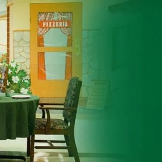 A cozy pizzeria interior with a table and chairs.