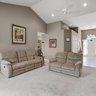 A cozy living room with sofas and artwork on the walls.