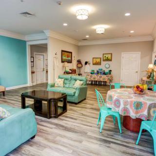 A modern living room with teal accents and colorful furniture, creating a cozy and inviting atmosphere.