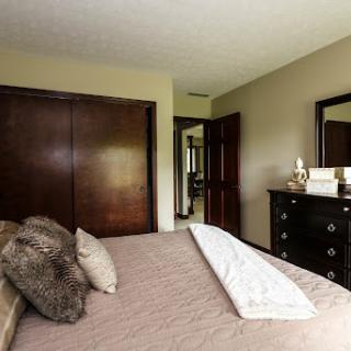 A cozy and well-decorated bedroom featuring a comfortable bed and stylish furniture.