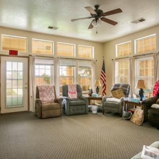 A cozy living room with comfortable recliner chairs and large windows allowing natural light.