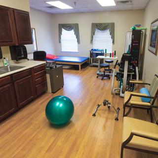 A physical therapy room equipped with exercise tools and treatment tables.