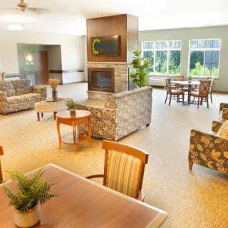 A spacious and modern lobby featuring comfortable seating areas, warm lighting, and elegant decor.