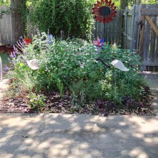 A vibrant garden filled with a variety of flowers, complemented by decorative elements.