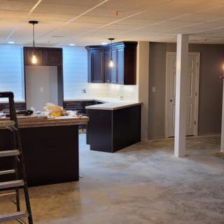 A modern kitchen with an island and pendant lighting in an open space.