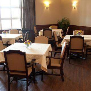 A cozy dining room with neatly set tables and chairs, ready for guests.