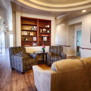 A cozy lounge with comfortable seating and a bookshelf.