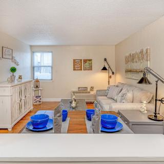 A cozy living and dining area featuring modern decor with blue accents and neutral tones.