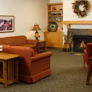A cozy living room with sofas, a coffee table, and a fireplace.