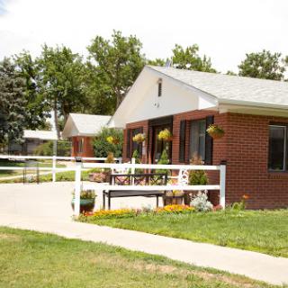 A charming residential house with a well-maintained garden and inviting walkway.