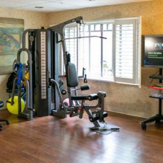 A well-equipped home gym with a multigym machine and exercise area.
