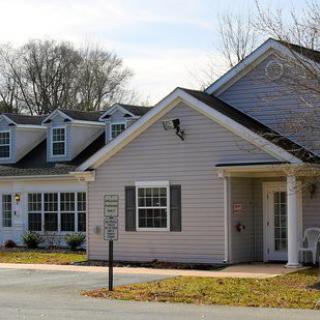 A suburban residential house with multiple dormers and a well-maintained exterior.