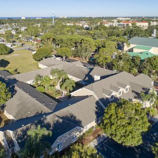 Aerial view of suburban buildings surrounded by lush greenery.