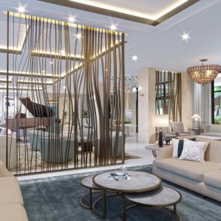 A modern living room with luxurious decor, featuring a stylish sofa, nested coffee tables, and an elegant partition wall.