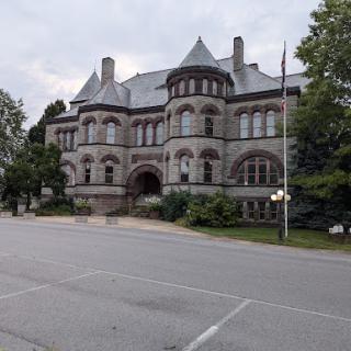 An impressive historic stone building with intricate architectural details, showcasing gothic design elements.