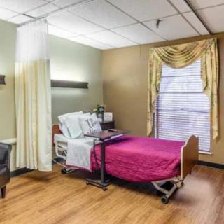 A well-organized hospital room with a bed and window.