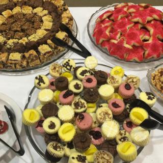 A variety of colorful desserts and pastries arranged on a buffet table.