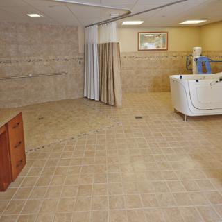 A spacious and soothing spa-like interior with tiled flooring and a bathtub.