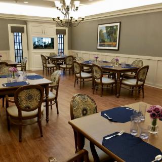 A well-decorated dining area with elegant furniture and a chandelier.