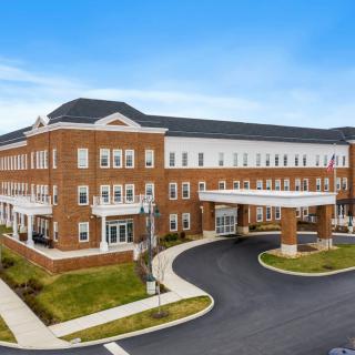 A modern healthcare facility with a prominent entrance and brick exterior.