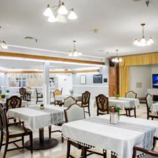 A well-lit restaurant dining area with neatly arranged tables and chairs.