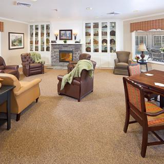 A cozy living room with comfortable seating, a fireplace, and warm decor.