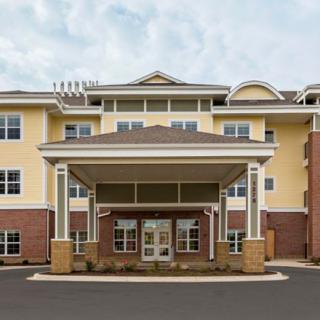 The exterior entrance of a hotel building with a covered driveway.
