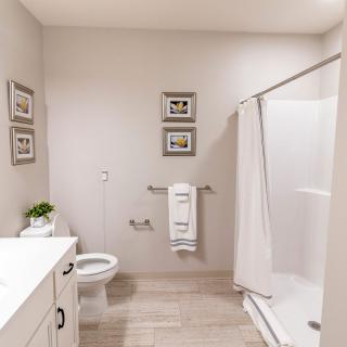 A clean, modern bathroom with a shower and minimalist decor.
