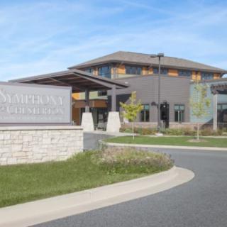 A modern building with a welcoming entrance and landscaped surroundings.