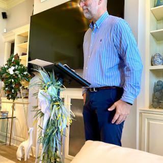 A man delivering a presentation in a stylish indoor setting.