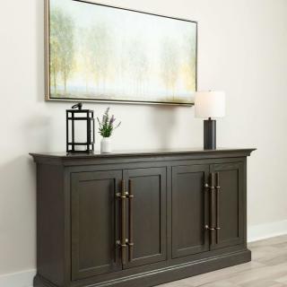 A modern sideboard with decorative items and a painting above.