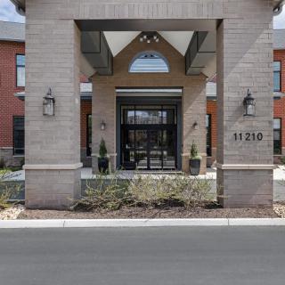 The entrance of a modern building with brick architecture.